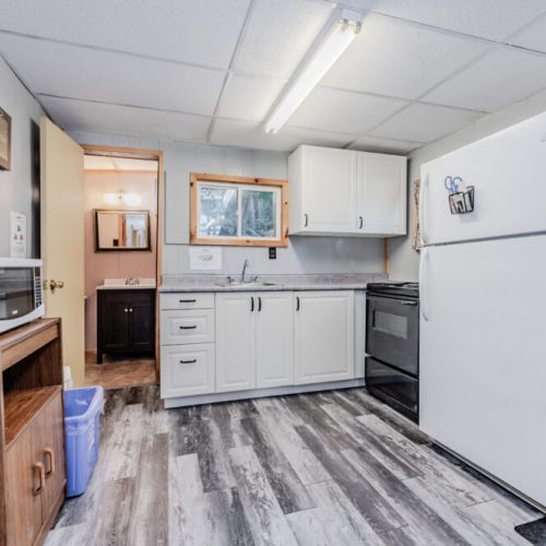 A well-equipped kitchen with a refrigerator, stove, and ample cabinet space, providing everything needed for cooking during your stay.