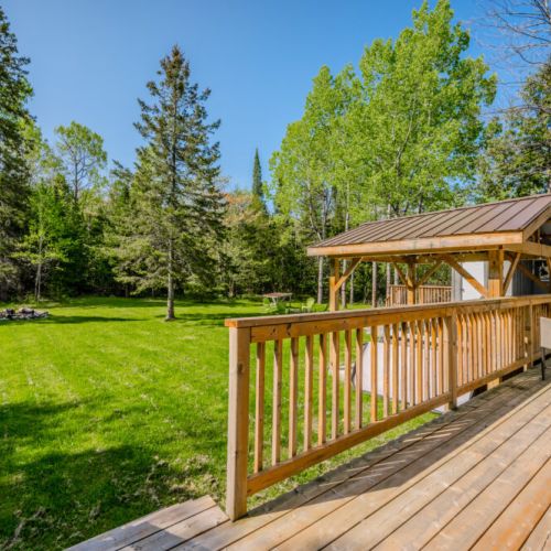A gazebo provides a shaded area for relaxation, while a fire pit in the yard offers a cozy spot for gatherings