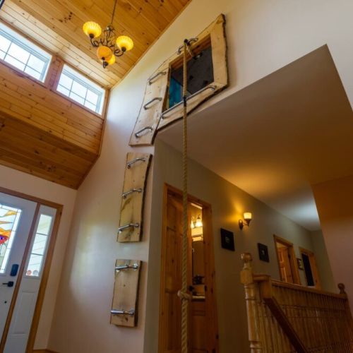 Unique vacation feature: access the climbing zone from the main floor using rustic ladders and ropes—perfect for thrill-seekers and kids.