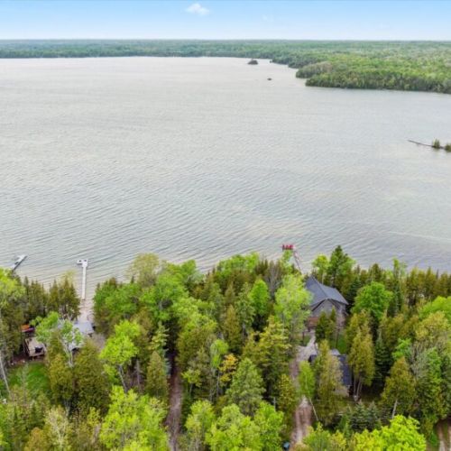 Experience the peaceful beauty of Berford Lake from above—Summer Side nestles quietly among the trees with private shoreline access, offering the ultimate lakefront getaway.