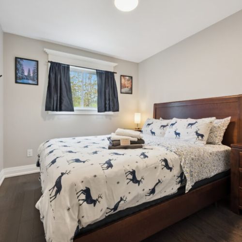Bedroom 3: The third bedroom features a queen-sized bed adorned with custom-made local Mennonite furniture, combining comfort and craftsmanship for a unique and cozy atmosphere.