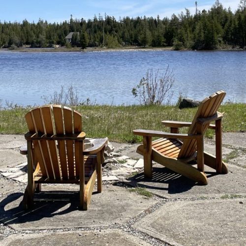 Relax by the water in classic Adirondack chairs