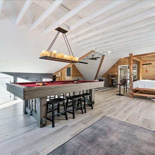 Loft entertainment zone featuring a pool table, seating, and plenty of space to unwind. A fun and unique spot for evenings in after a day outside.