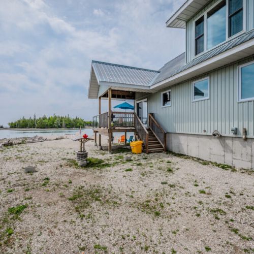 This angle shows the cottage's proximity to Lake Huron, offering direct access to the water and beautiful views from the property.