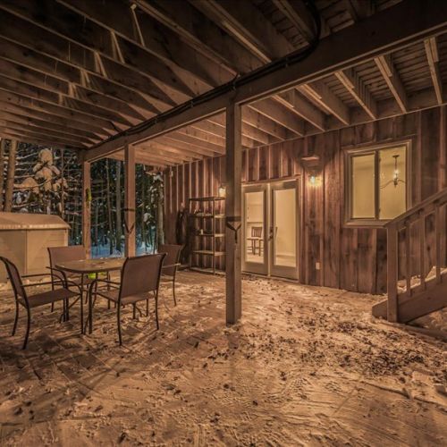 A rustic shared cabin hangout with a cozy, sheltered patio area. Great for games nights, reading, or simply enjoying a change of scenery.