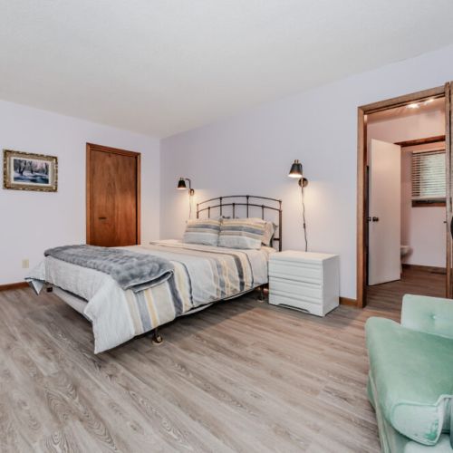 Sleep peacefully in a bright, airy bedroom with ensuite bathroom access—ideal for a restful vacation retreat near the water.