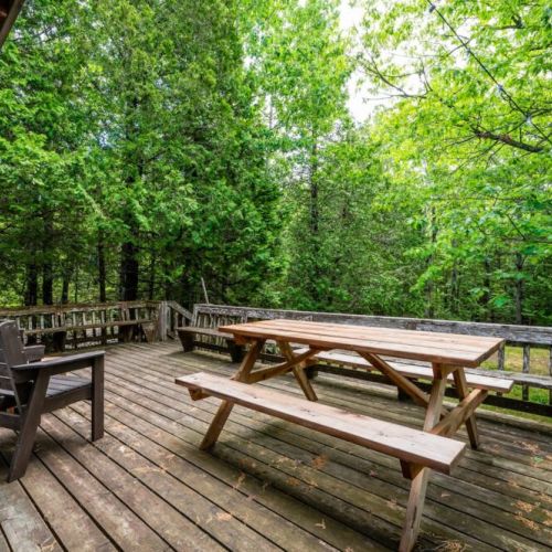Large deck with bench seating and patio furniture.