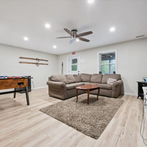 The lower-level rec room is perfect for games, relaxing, and extra indoor space for families.