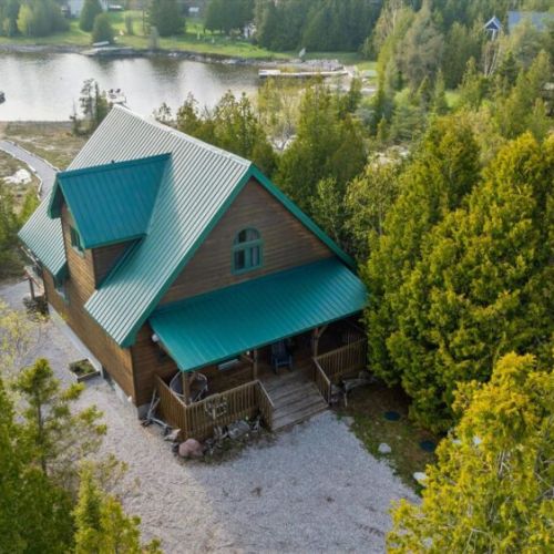 The spacious rear deck and outdoor lounge area are perfect for soaking up the sunshine and lake views.