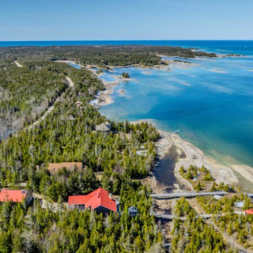 Breathtaking coastal view with pristine shoreline and lush forest—perfect for secluded getaways, kayaking adventures, and peaceful lakeside living.