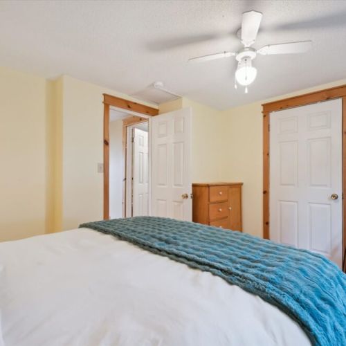 Bedroom 2: Relax in a cozy bedroom featuring warm natural light, ample storage, and easy access to nearby amenities.