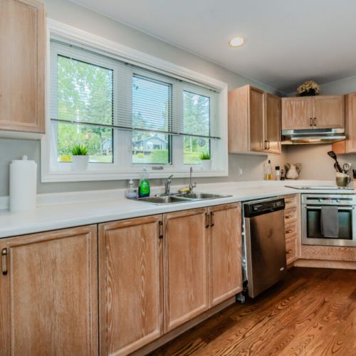The kitchen is stocked with modern appliances and offers a peaceful view of the quiet, tree-lined neighborhood. Perfectly equipped for all your cooking needs, it’s the ideal space to prepare meals during your Bruce Peninsula getaway.