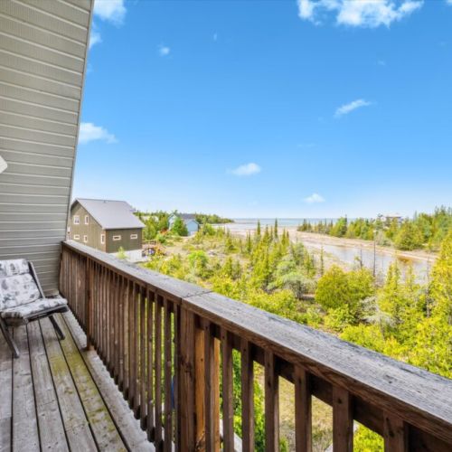Step out from the primary bedroom to your private balcony and take in sweeping views of Dorcas Bay and Lake Huron.