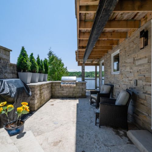 Private lower patio with shaded seating—perfect for relaxing on warm summer days.