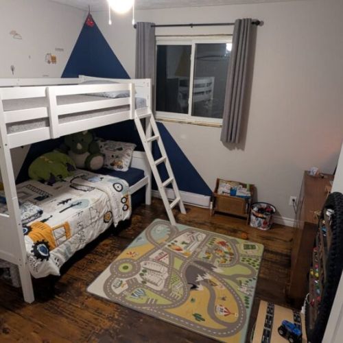 Bedroom 2: Fun bunk bed room perfect for kids, featuring a double bed below, twin above, and playful décor.
