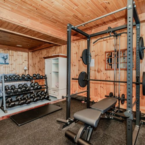 Unique bedroom-gym combo with full weight rack and cozy sleeping space—ideal for fitness-focused travellers or couples seeking a well-rounded retreat.
