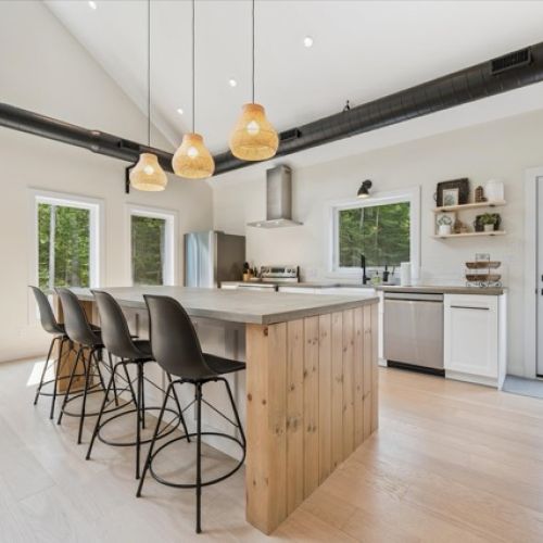 Vaulted ceilings, a wall of windows, and modern-rustic décor create a warm and welcoming space for families and groups.
