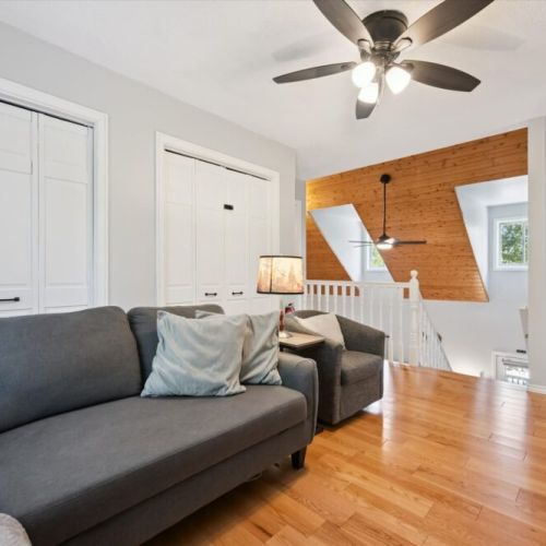 Bright loft sitting area overlooking the great room below, offering a quiet space to read or gather.