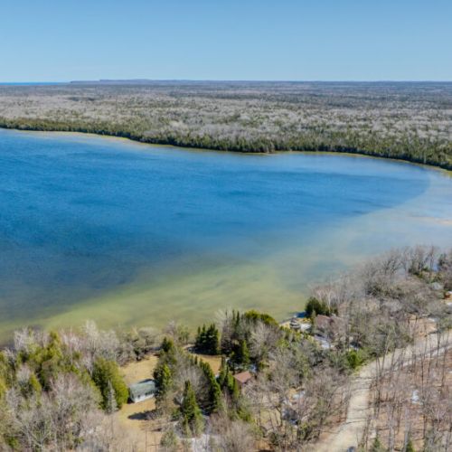 Panoramic view of the lake with pristine beaches and untouched nature, offering an idyllic setting for a serene lakeside cottage escape.