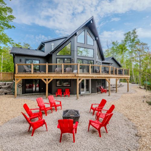 Enjoy sunny days at the fire pit area, with bright red Adirondack chairs ready for your group. Perfect for daytime relaxation or evening campfires, this spot promises fun and togetherness.