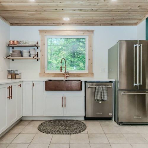 This fully equipped kitchen blends stainless style with cottage charm—ideal for prepping snacks, meals, or a morning coffee before a day of exploring Bruce Peninsula.