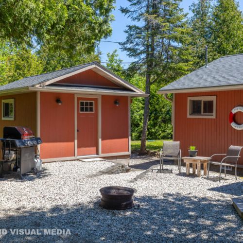 Comfortable outdoor space with a BBQ, fire pit, and chairs—perfect for outdoor dining and relaxing.