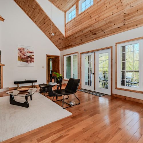 Natural light floods the lounge through French doors, perfect for unwinding on your nature retreat.