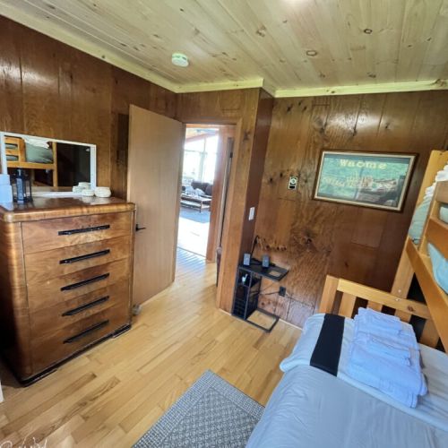 The bunk room, ideal for additional guests or children, with natural light and cozy wooden interiors.