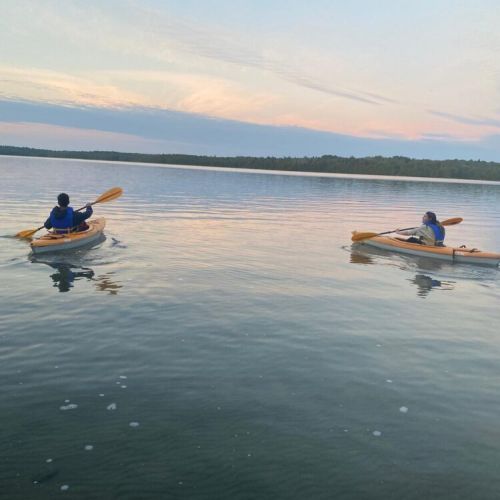 Paddle tranquil waters as the sky glows—sunset kayaking offers a serene and unforgettable vacation experience.