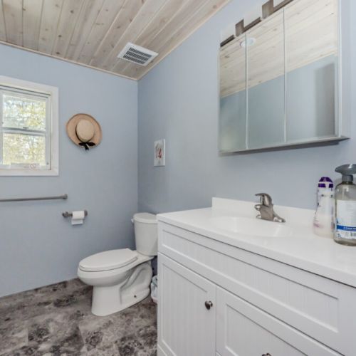 A second bathroom provides convenience and comfort for all guests, with homey decor and clean lines.