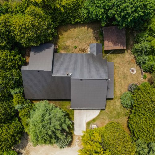 An eagle's eye view of Howdenvale Haven, showcasing the property's expansive layout and its lush, green surroundings, promising privacy and peace.