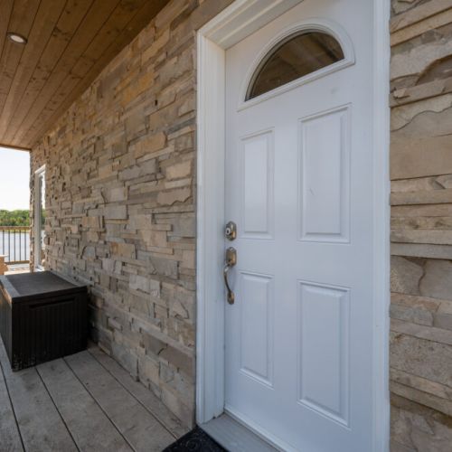 Private exterior entrance with charming stonework and easy access to the cottage.