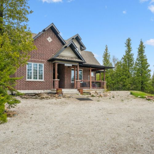 Private driveway and front view of The Brick House, offering privacy and a peaceful arrival surrounded by nature