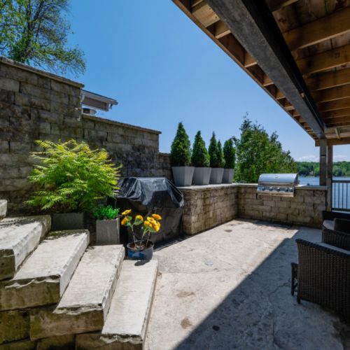 Private patio with BBQ and additional seating for outdoor cooking and entertaining.