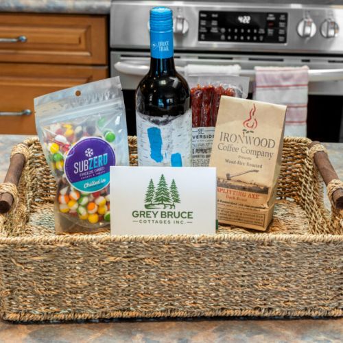 A thoughtful Grey Bruce Cottages welcome basket greets guests with a selection of treats to start their stay.