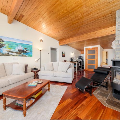 Comfortable seating, a wood-burning fireplace, and soaring ceilings create the perfect place to unwind.