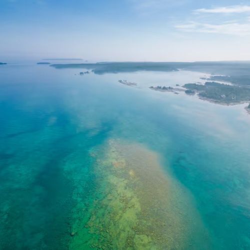 Stunning wide view of Lake Huron’s turquoise waters stretching endlessly — perfect for kayaking, boating, and unforgettable sunsets.