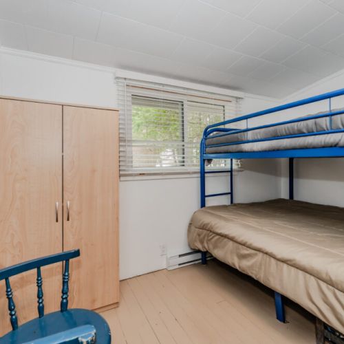 This bright, simple bunk room is perfect for kids or extra guests—sleep comfortably after a day at the lake.