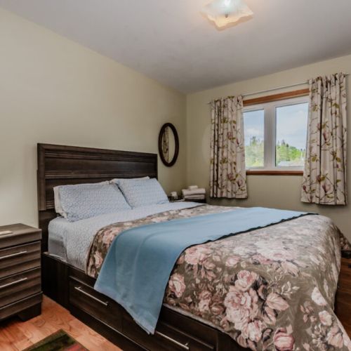 Bright and inviting bedroom with a view of the surrounding nature. A cozy retreat for couples or solo travelers looking to recharge.