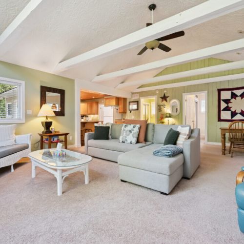 Bright, open-concept living space with vaulted ceilings and comfy seating for relaxing together.