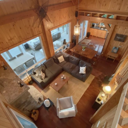 An overhead perspective of the living and dining space, beautifully designed to complement the natural surroundings and capture every ray of light.