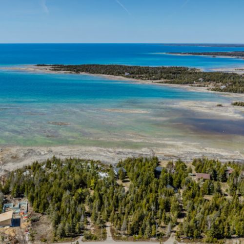 Breathtaking coastal aerial views showcasing crystal-clear waters, rugged shoreline, and untouched natural beauty — your dream vacation spot!