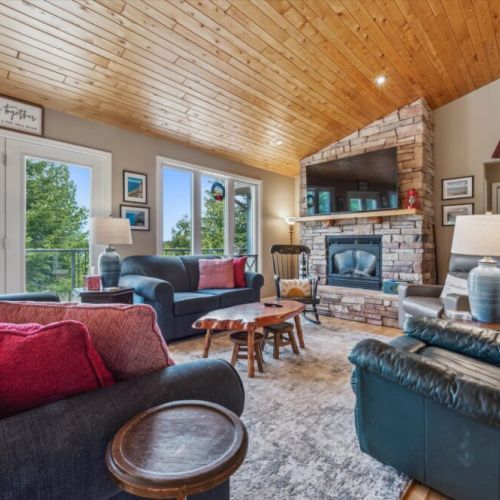 Gather around the fireplace or enjoy views of the bay from this cozy and light-filled central space.