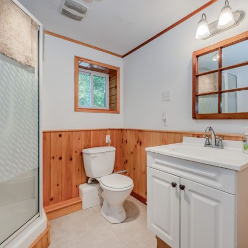 Bright and cozy bathroom with rustic wood details and a full shower — the perfect space to refresh after a day of exploring.