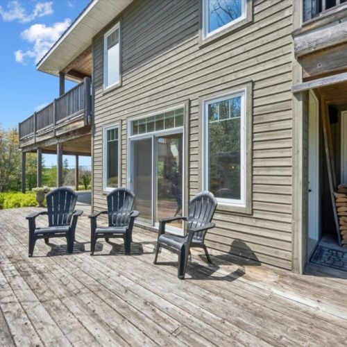 Spacious lower deck seating area perfect for relaxing outdoors in peaceful surroundings.