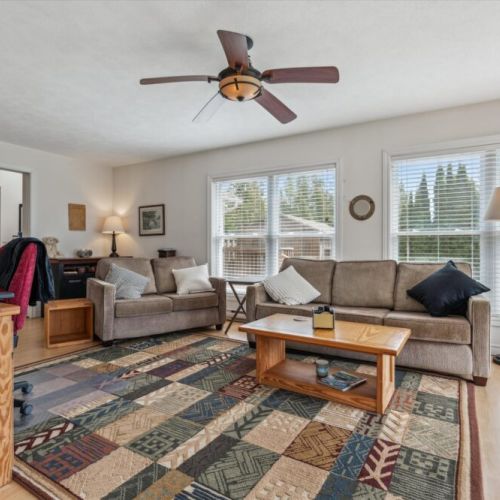 Plenty of comfy seating and natural light make this living area a perfect hangout spot for families and friends.