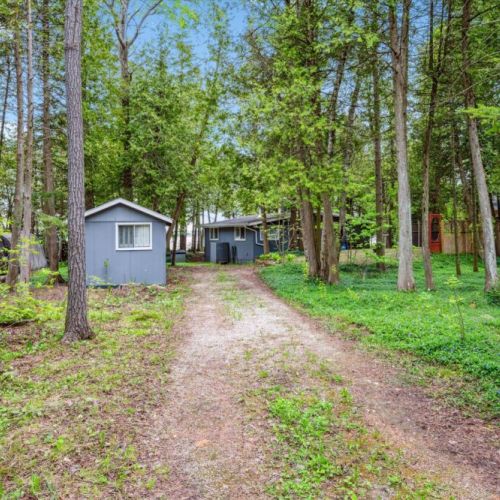 A peaceful, wooded driveway leads you into your private escape at Summer Side, where your tranquil cottage retreat awaits just steps from the lake.