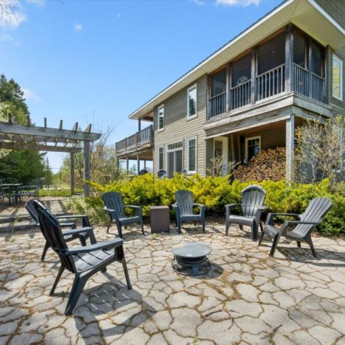 Expansive outdoor entertaining space with patio seating and landscaped surroundings.