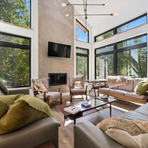 Relax in the bright great room with soaring ceilings and a cozy fireplace.