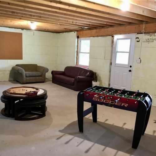 The lower-level rec room is perfect for games, relaxing, and extra indoor space for families.